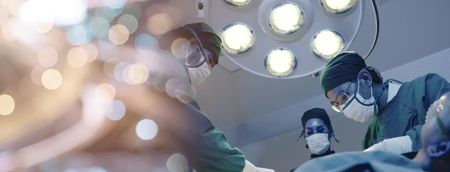 Surgeons operating under theatre lights
