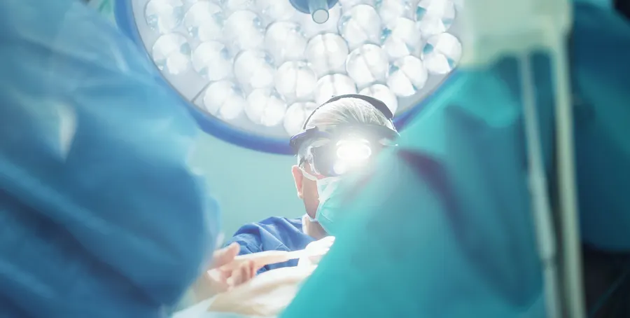 Operating theatre lights over a surgical team